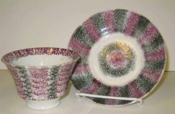 Appraisal: ENGLISH SPATTERWARE Purple and black rainbow bull's eye spatter handless