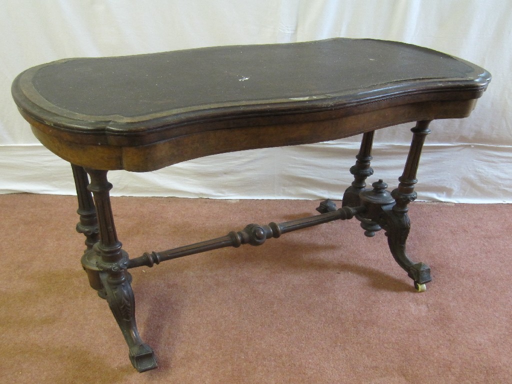 Appraisal: A Victorian walnut turnover games table raised on two fluted