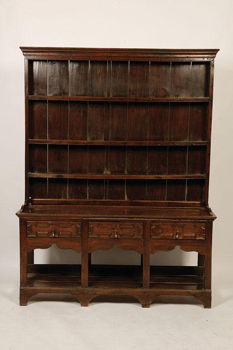 Appraisal: A GEORGE II OAK DRESSER the raised shelved back above