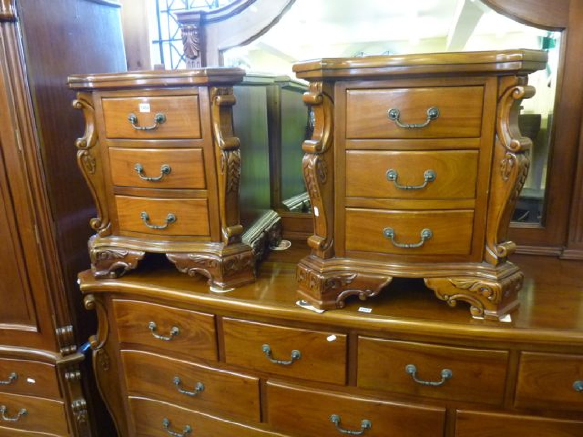 Appraisal: A pair of mahogany side cabinets each enclosing three frieze