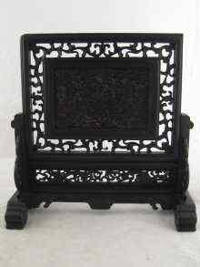 Appraisal: An intricately formed Oriental tortoiseshell screen the central panel with