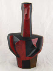 Appraisal: A Spanish vase formed as a stylised man in red