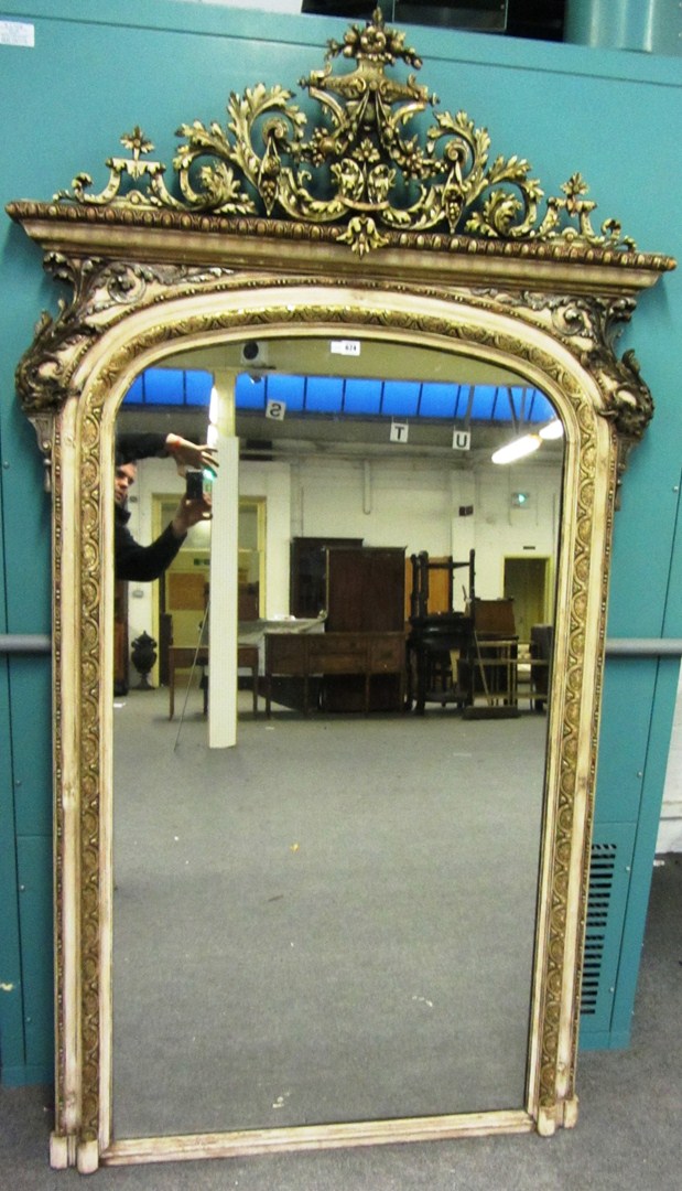 Appraisal: A th century cream and parcel gilt overmantel mirror the