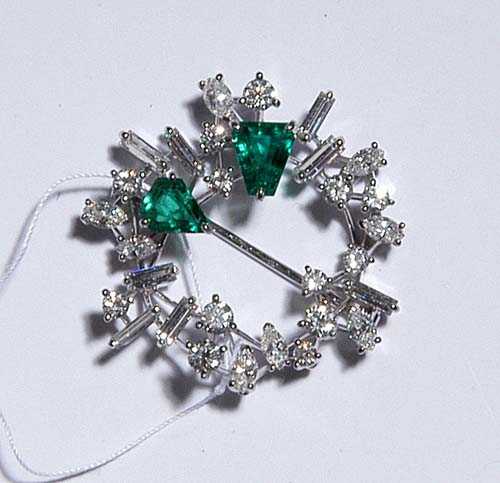 Appraisal: DIAMOND AND EMERALD BROOCH E MEISTER White gold Very elegant