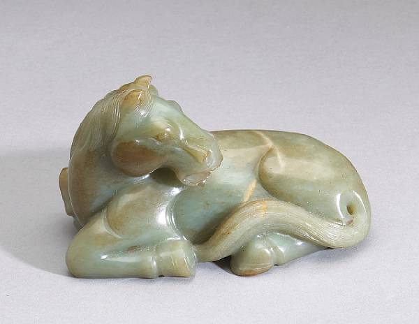 Appraisal: A green nephrite model of a horse The recumbent beast