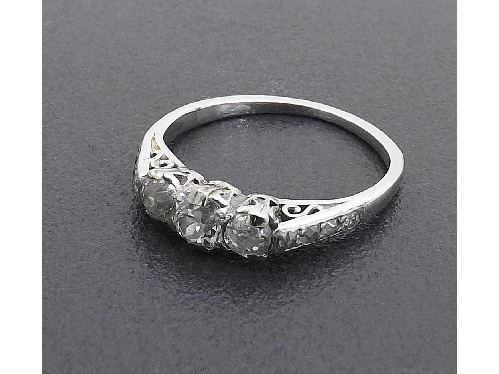 Appraisal: Platinum three stone diamond ring with diamond set shoulders ring