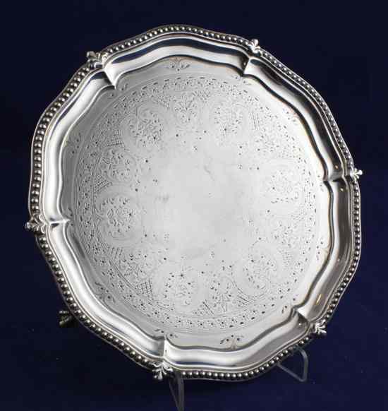 Appraisal: A Victorian engraved silver waiter of shaped circular form with