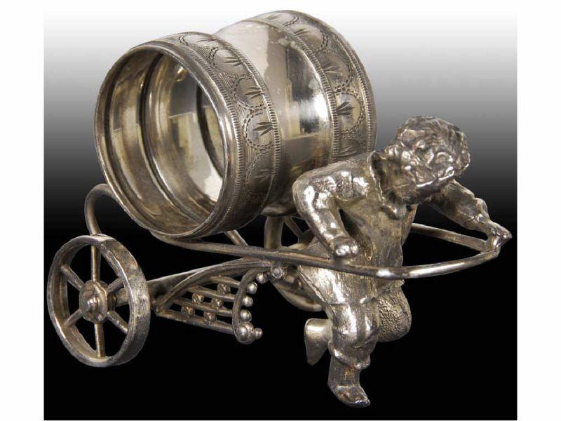 Appraisal: Boy Pulling Figural Napkin Ring on Wheels Description Fancy fret