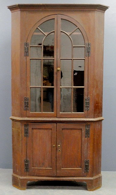 Appraisal: - Pennsylvania one-piece corner cupboard c with brown paint decoration