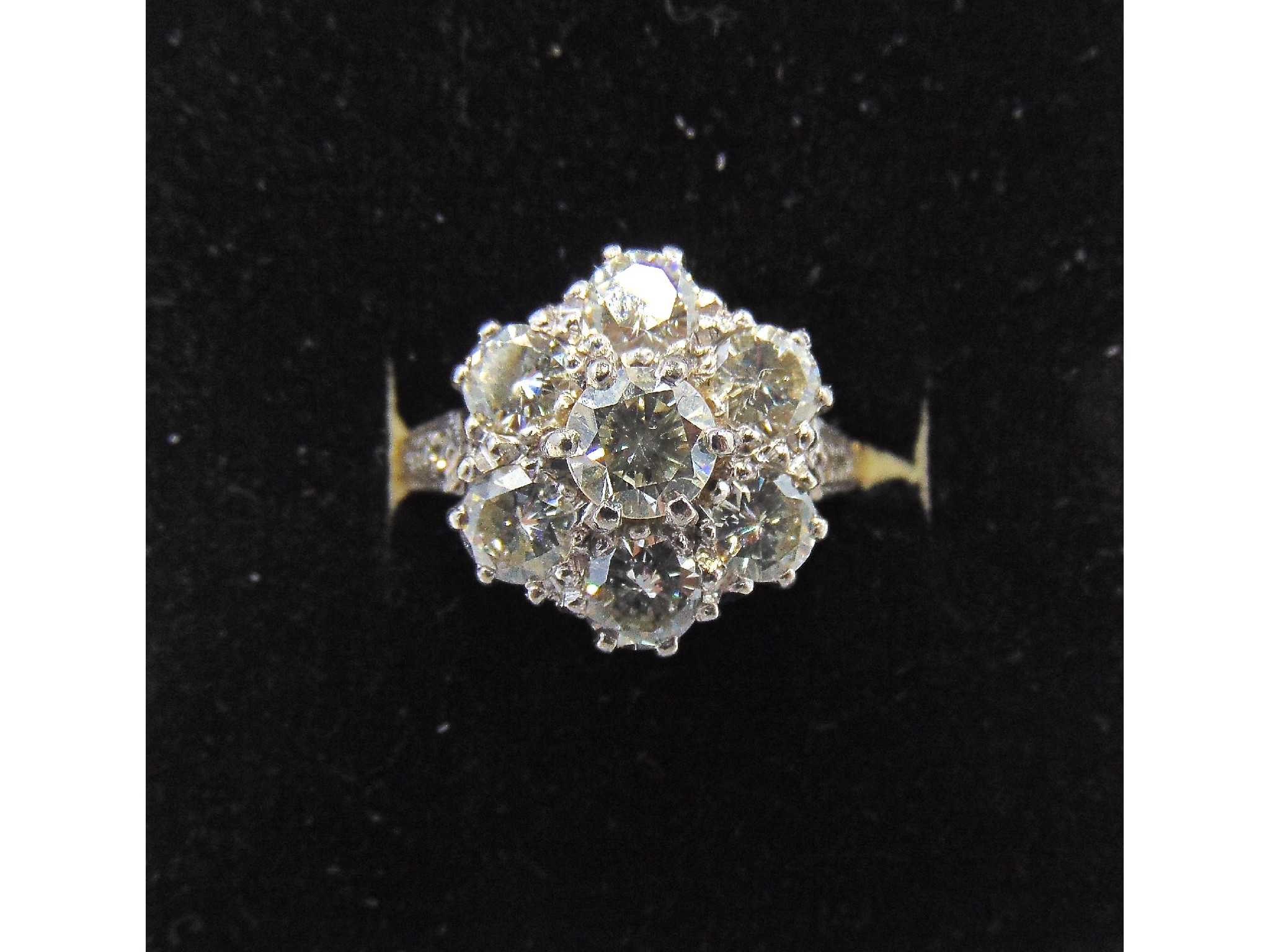 Appraisal: A diamond flower head cluster ring centred with a round