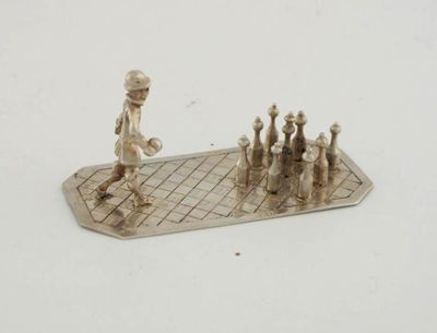 Appraisal: A gentleman playing nine-pin skittles on a checkerboard base in