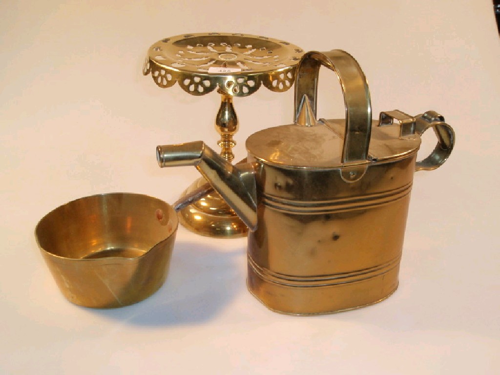 Appraisal: A thC brass pedestal trivet a brass water can and