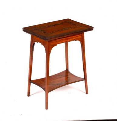 Appraisal: An Edwardian satinwood card table with painted floral swag decoration