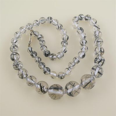 Appraisal: A row of graduated rutilated quartz beads the largest mm