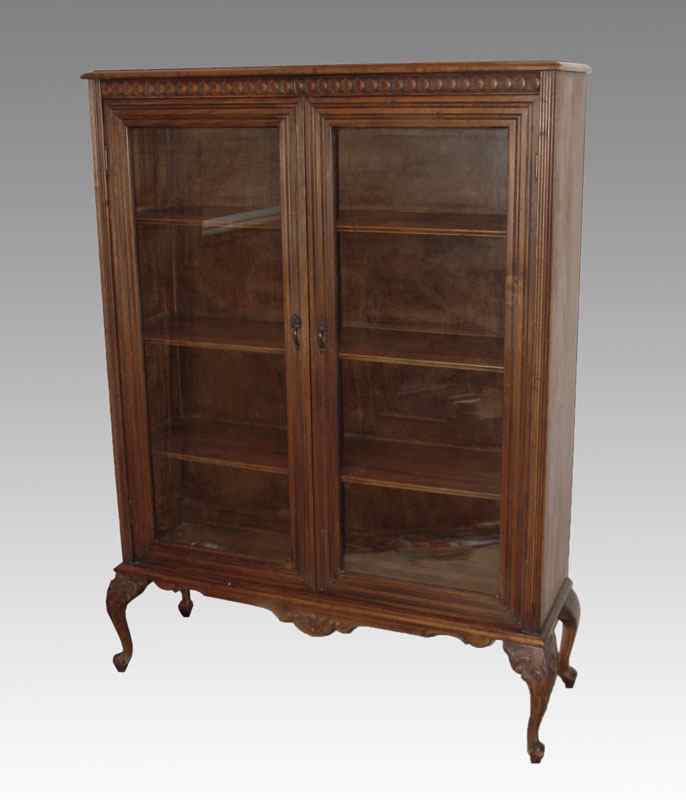 Appraisal: TWO DOOR BOOKCASE ON CARVED FEET glass doors with wood