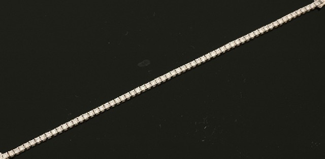 Appraisal: A diamond line bracelet Claw set with sixty four round