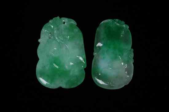 Appraisal: TWO CHINESE APPLE GREEN AND CELADON JADEITE PENDANTS One ruyi