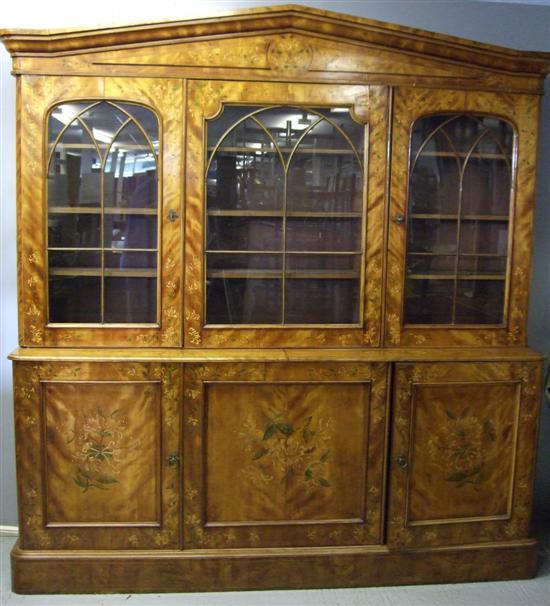 Appraisal: Victorian floral painted satinwood library bookcase with triangular pediment and