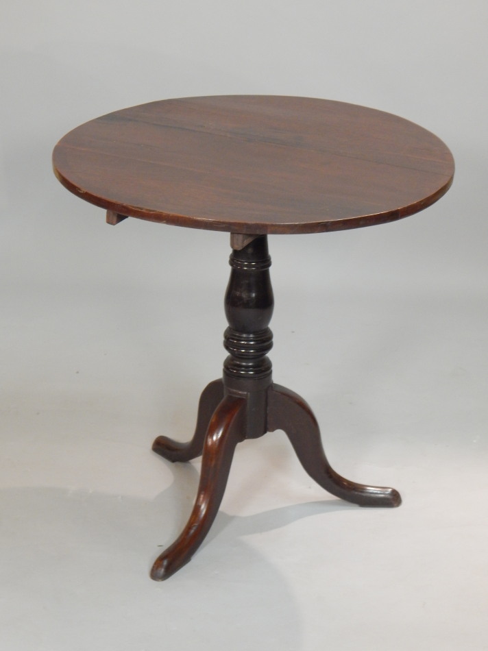 Appraisal: A George III oak tilt top table the circular top