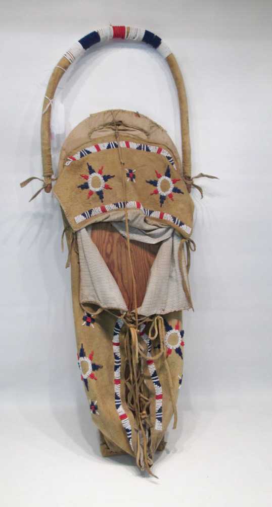 Appraisal: NATIVE AMERICAN PLATEAU CRADLE the cover made of cloth lined