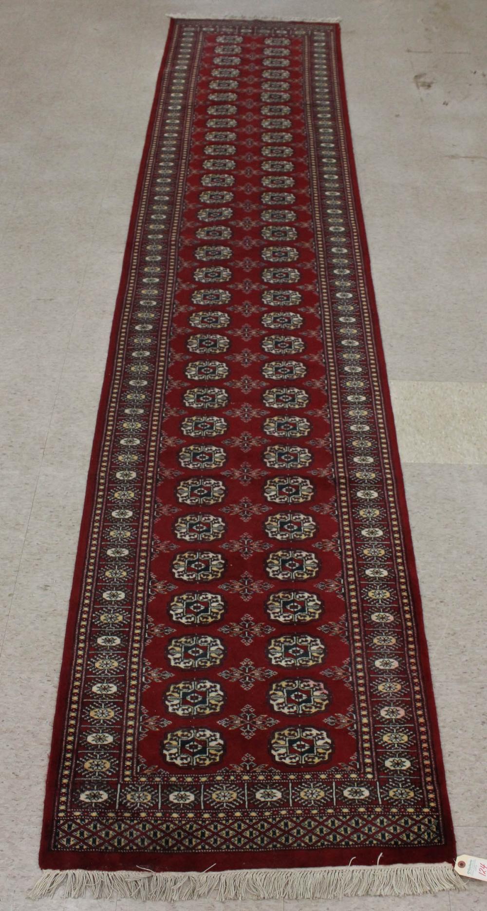 Appraisal: HAND KNOTTED RED BOKHARA RUNNER Turkman gol design ' x