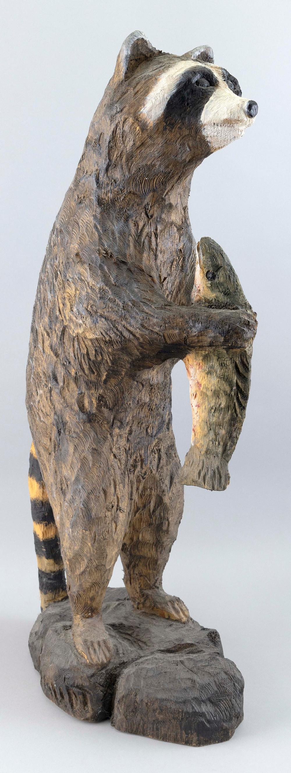 Appraisal: CARVED AND PAINTED WOODEN RACCOON HOLDING A RAINBOW TROUT LATE