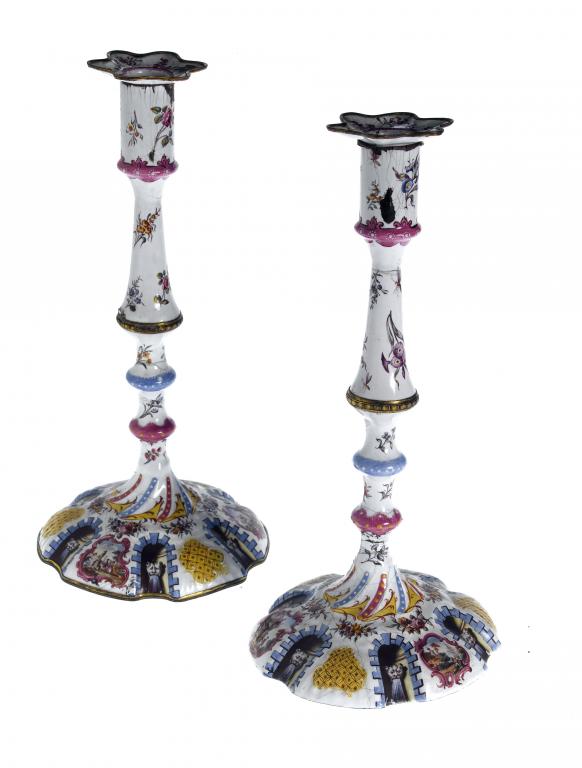 Appraisal: A PAIR OF CONTINENTAL ENAMEL CANDLESTICKS with nozzle and knopped