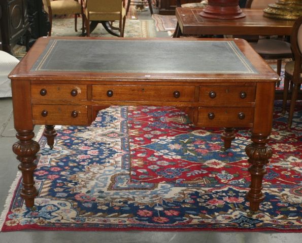 Appraisal: A Victorian mahogany desk with inserted green tooled leather top