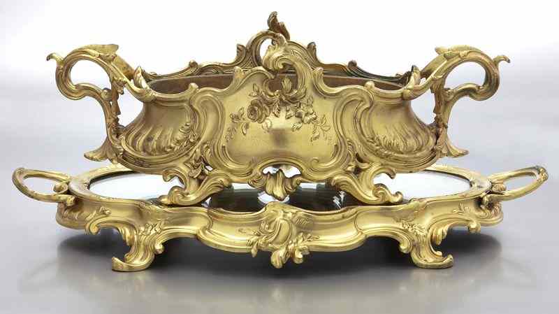 Appraisal: Louis XV style gilt bronze centerpieceresting on a mirrored stand