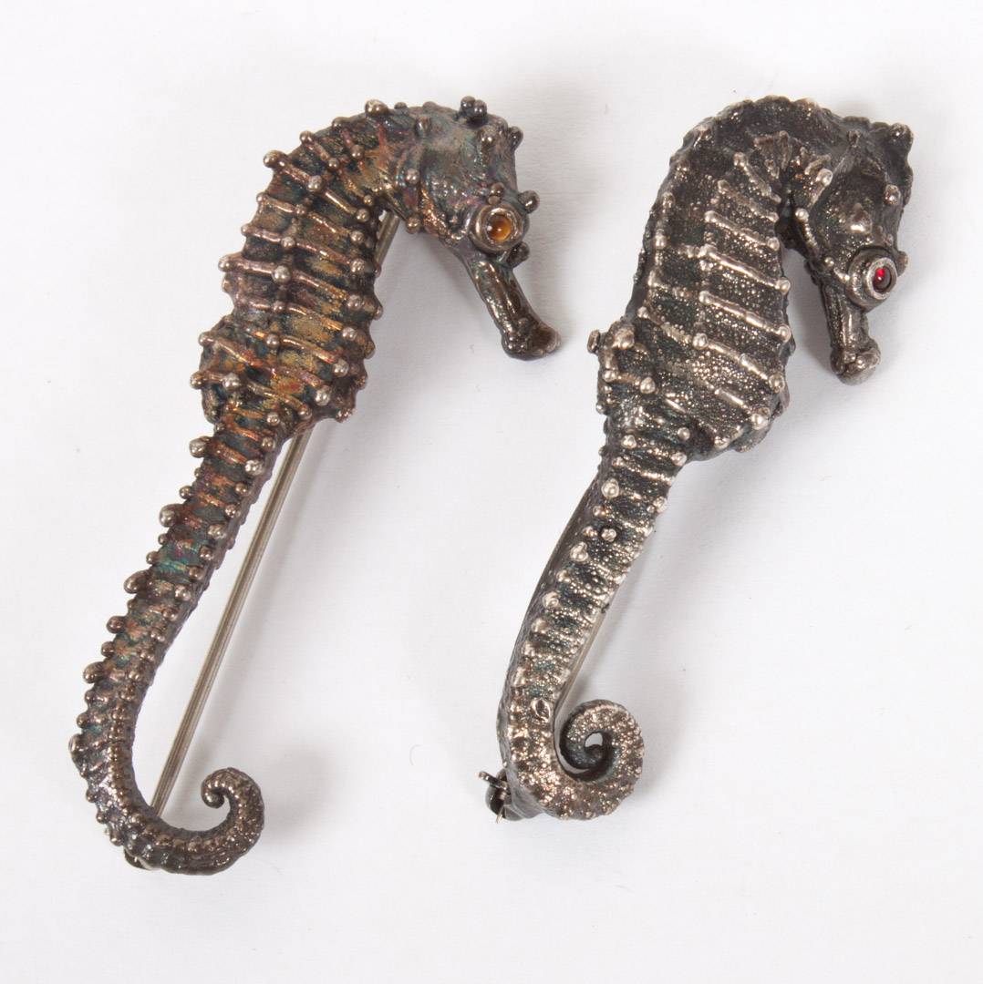 Appraisal: Two Carl Schon sterling Seahorse brooches with tiger-eye cabochon in