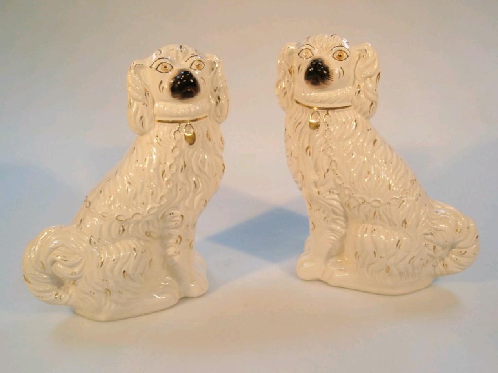 Appraisal: A pair of late Victorian Staffordshire King Charles spaniel comforter