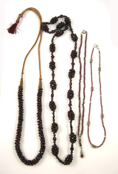 Appraisal: FOUR GARNET NECKLACES the first a with garnet clusters between