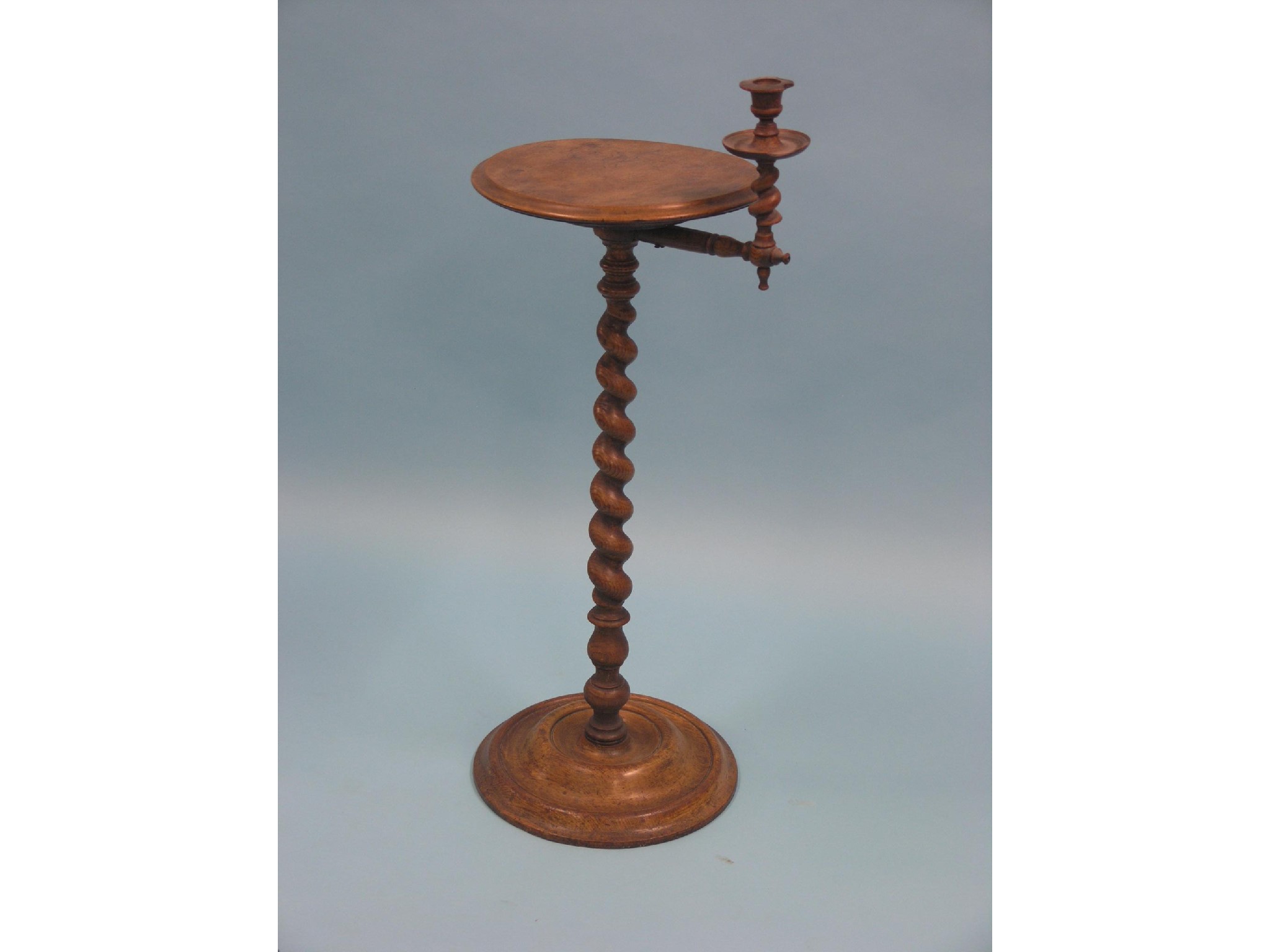 Appraisal: A Victorian oak candle-stand circular top with adjacent sconce barley-twist