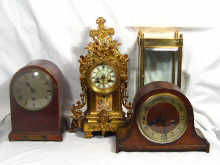 Appraisal: A gilded spelter mantel clock with a porcelain panel front