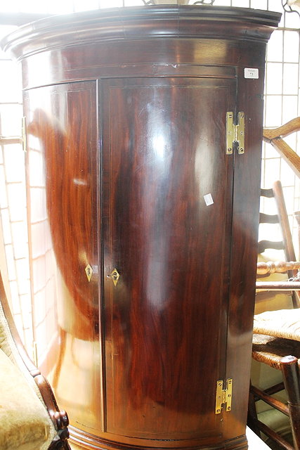 Appraisal: A GEORGE III MAHOGANY BOW FRONT CORNER CUPBOARD with fitted