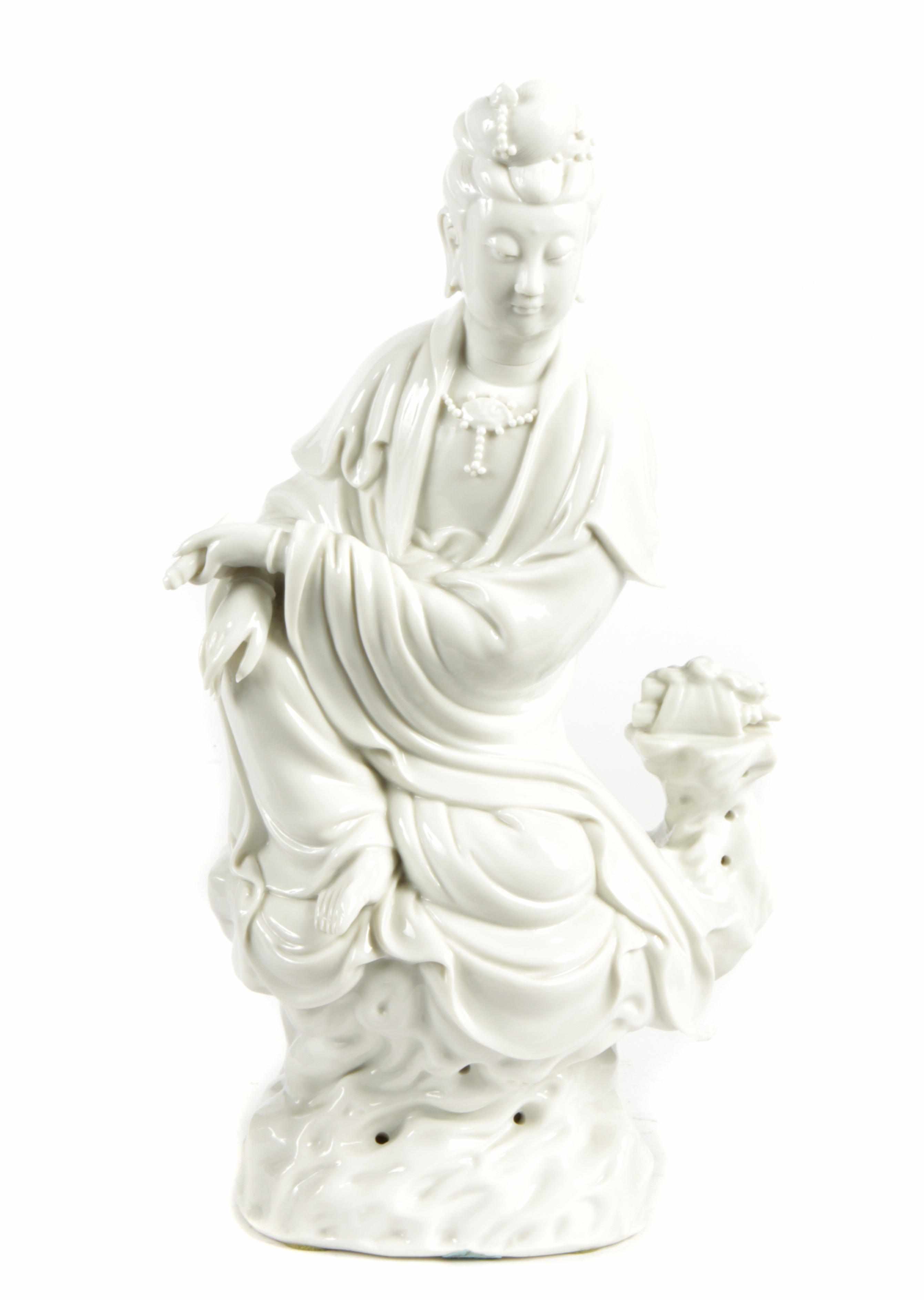 Appraisal: A blanc de chine seated figure of Guanyin holding a