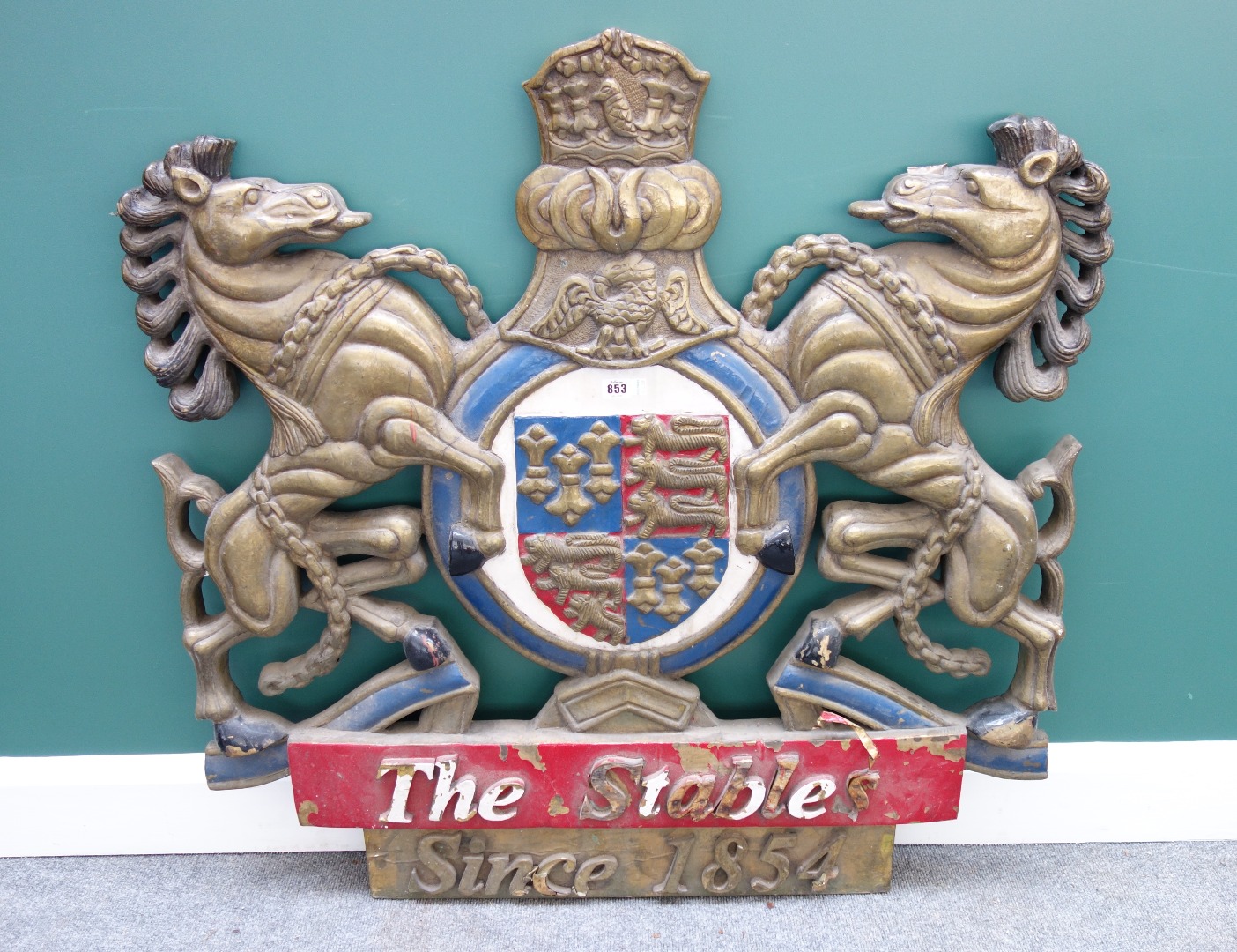 Appraisal: A wood and sheet metal mounted coat of arms titled