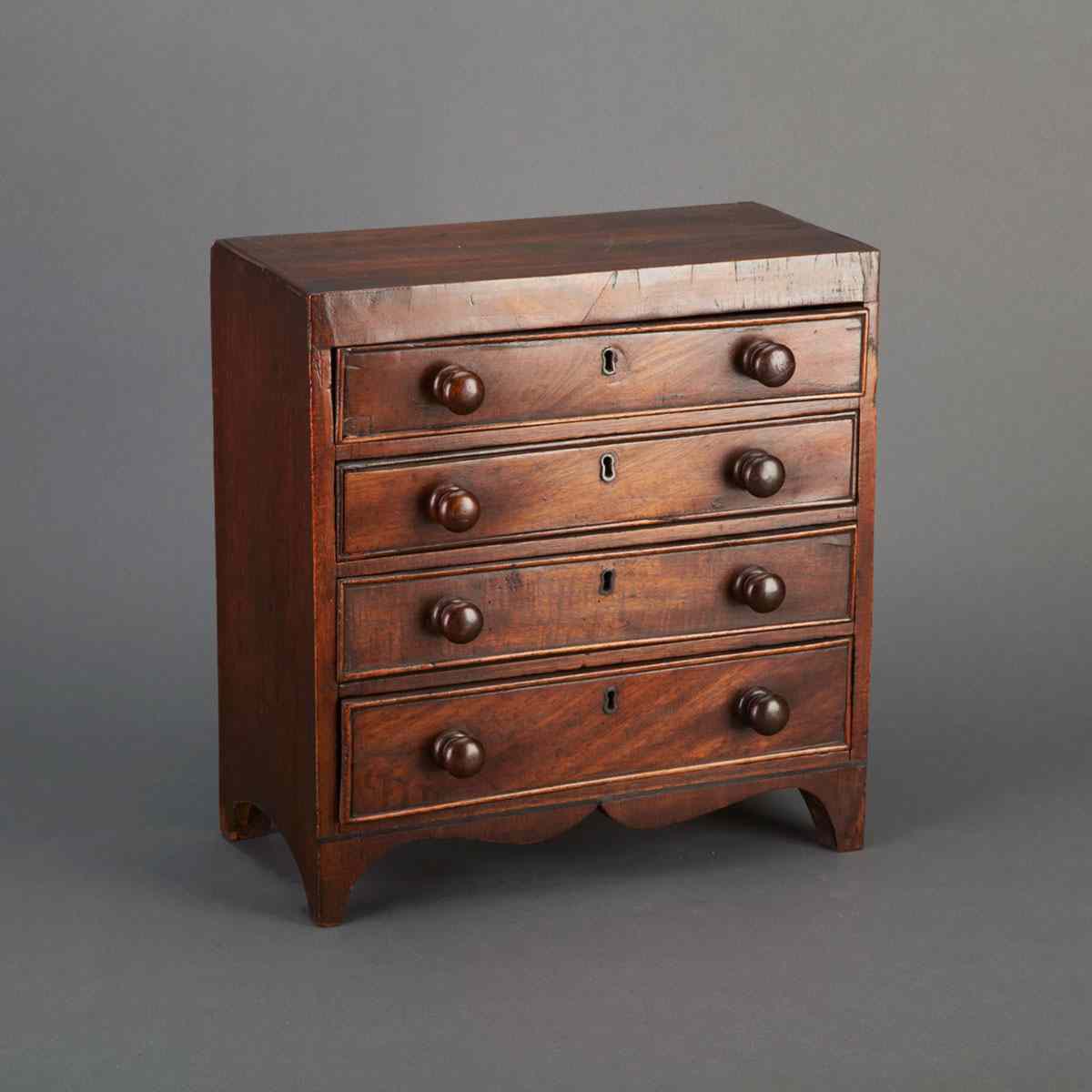 Appraisal: Miniature Mahogany Chest of Drawers c with four bead edged