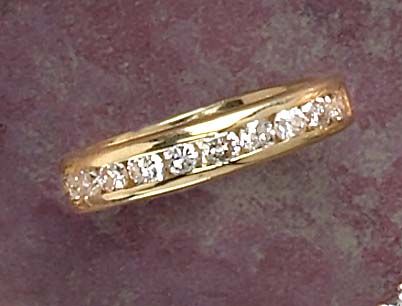 Appraisal: DIAMOND WEDDING RING k yellow gold comfort fit channel set