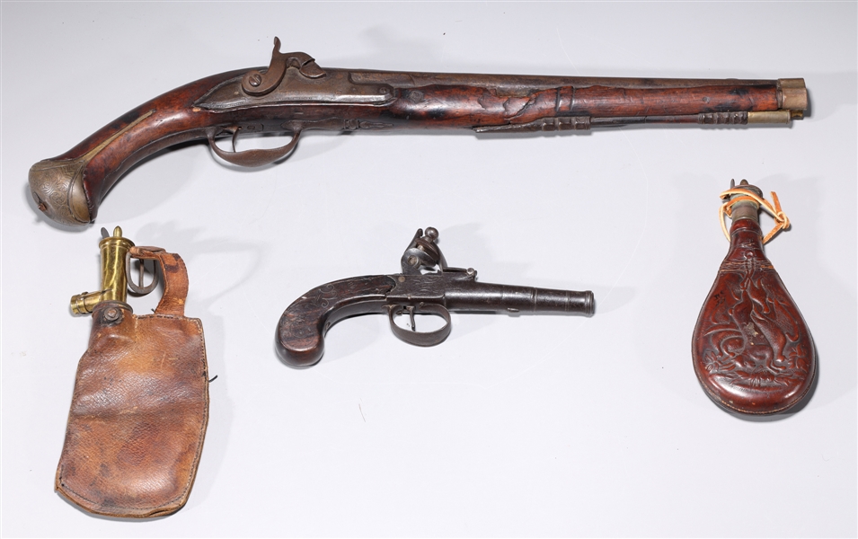 Appraisal: Two antique non-functional pistols and two leather powder pouches late