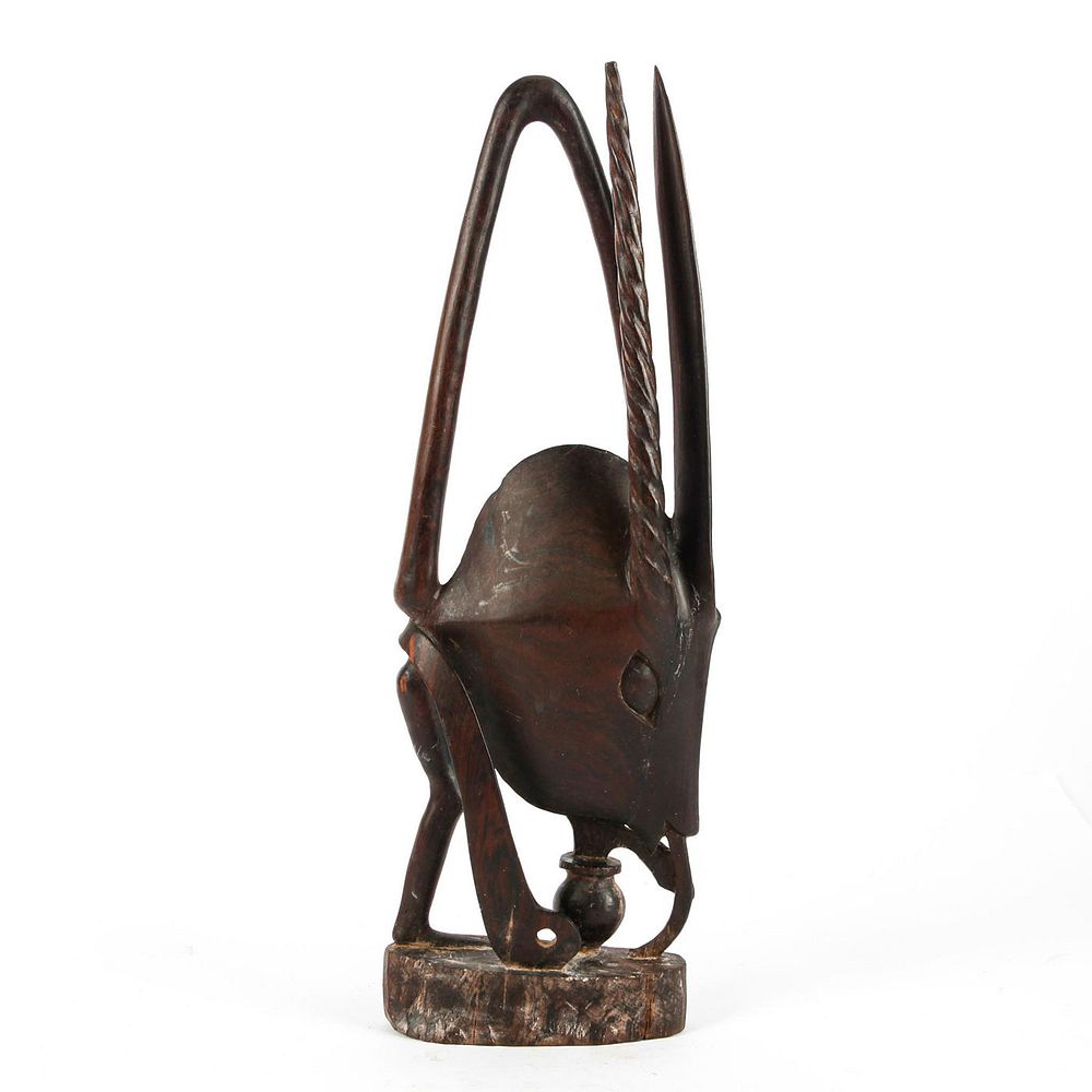 Appraisal: AFRICAN WOODEN FIGURE ANT DRINKING FROM PLANT Surrealist carved figure