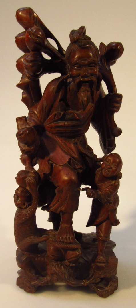 Appraisal: A late Qing Chinese hardwood figure group of a sage