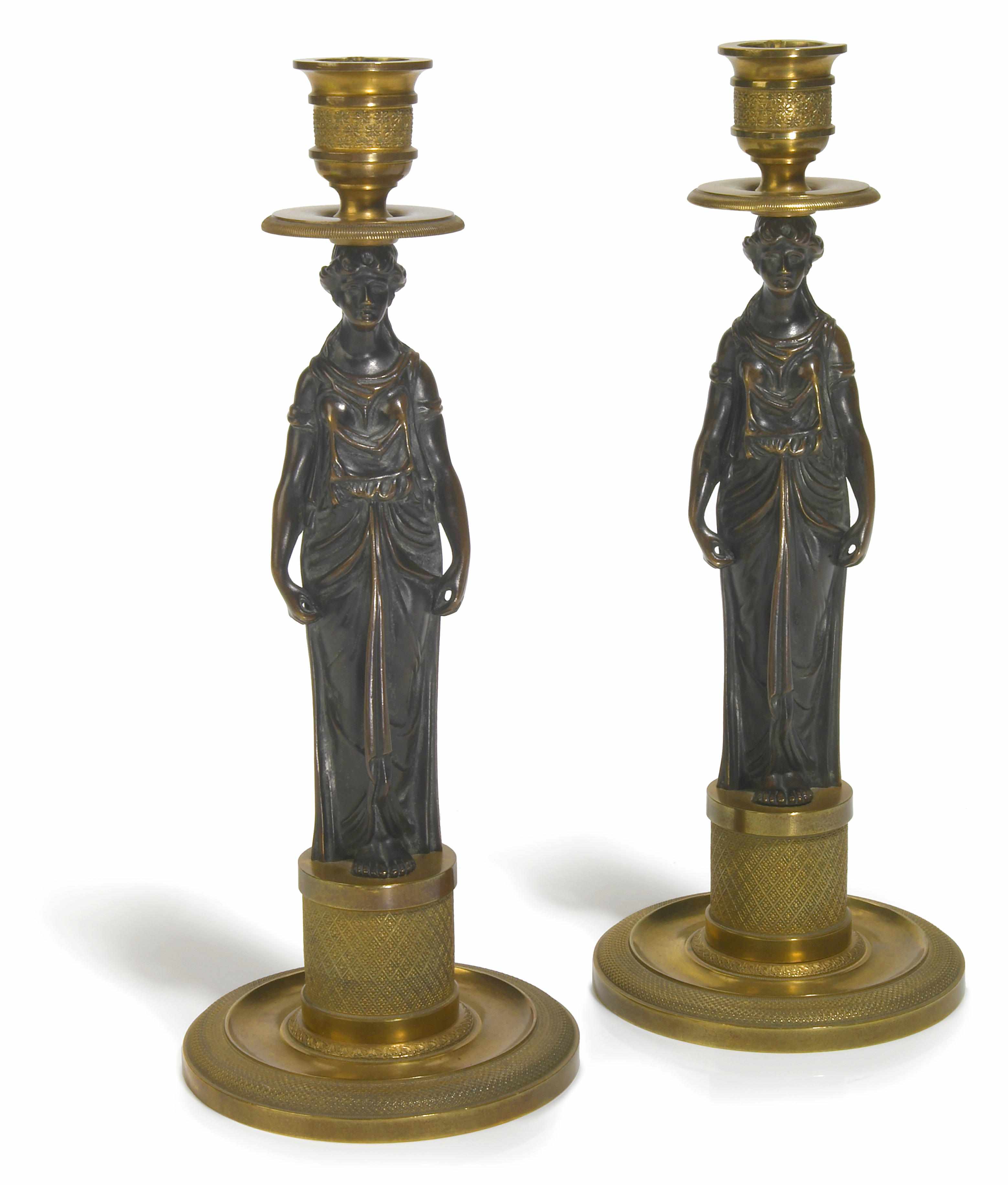 Appraisal: A pair of Austrian gilt and patinated bronze figural candlesticks