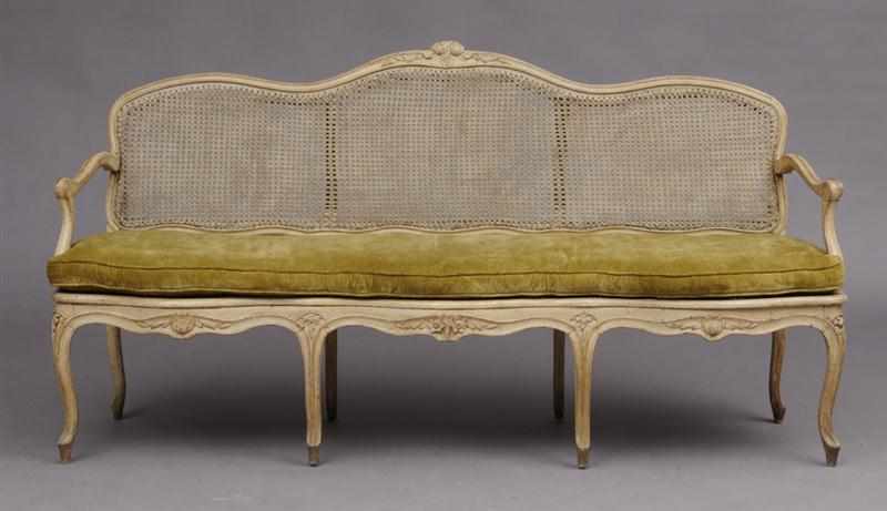 Appraisal: LOUIS XV CARVED AND CREAM-PAINTED SETTEE The serpentine top rail