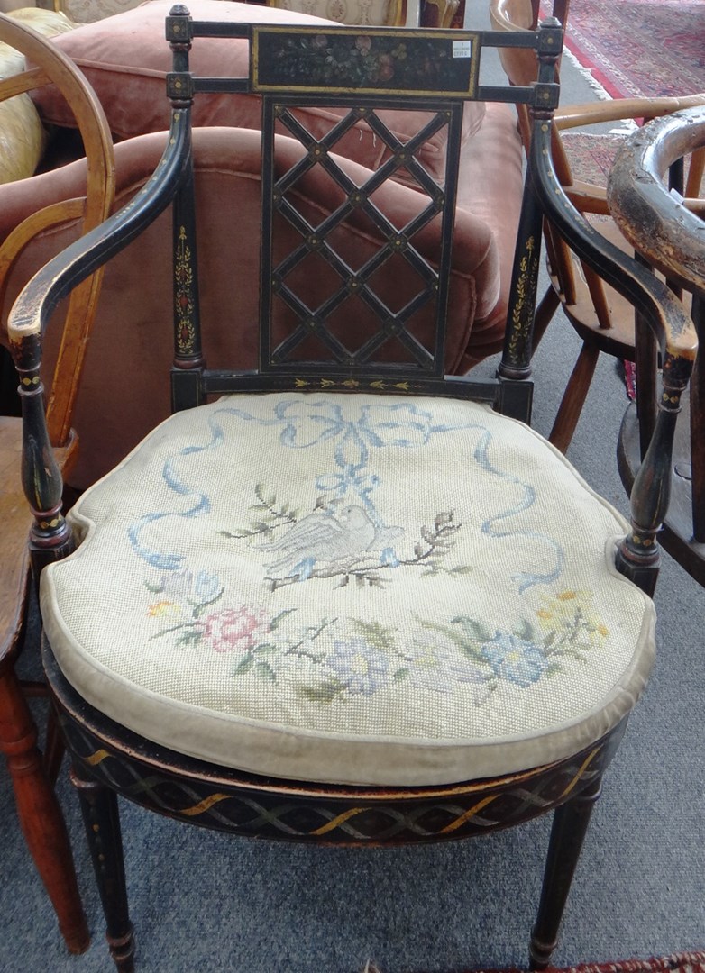 Appraisal: An early th century floral painted ebonised beech open armchair