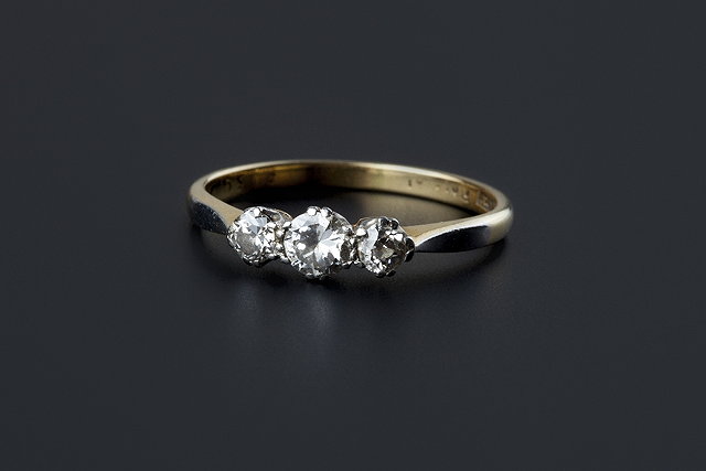 Appraisal: A diamond three stone ring claw set with graduated brilliant