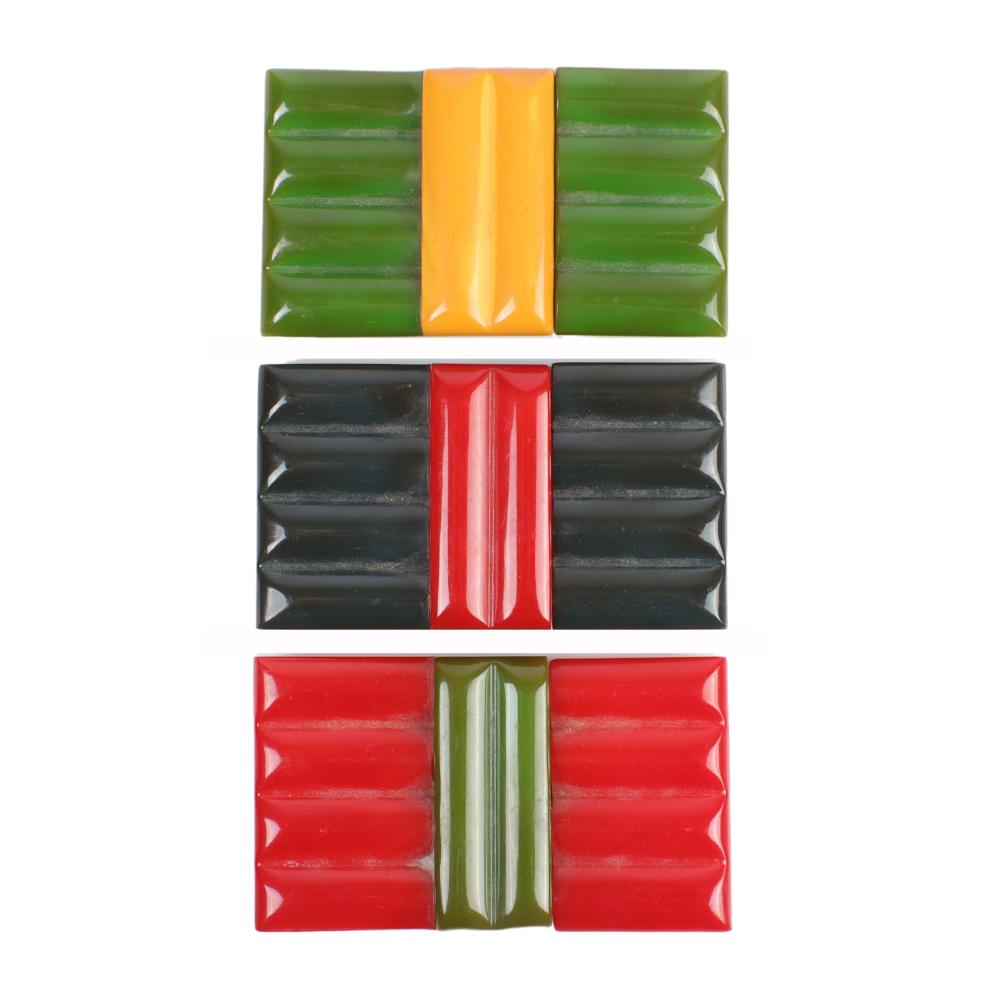 Appraisal: SET OF BAKELITE BELT BUCKLES IN -COLOR CARVED GEOMETRIC RIDGED