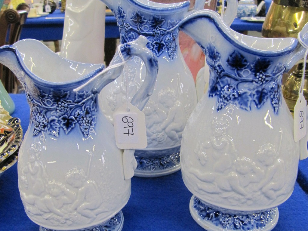 Appraisal: Set of three pottery jugs with moulded relief decoration of