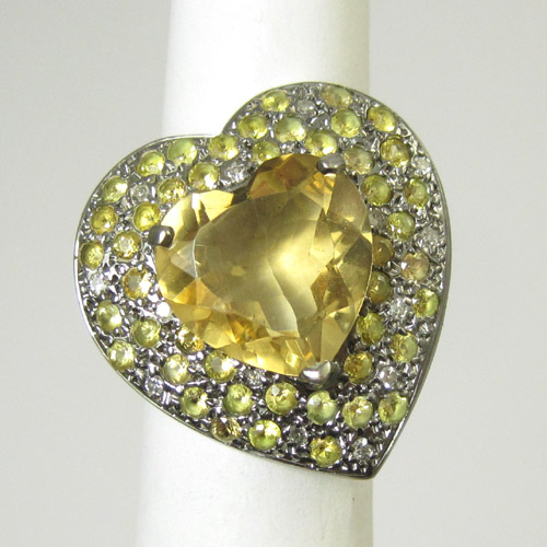 Appraisal: CITRINE DIAMOND AND YELLOW SAPPHIRE RING The heart setting with