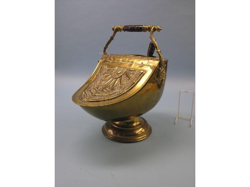 Appraisal: A late th century brass coal scuttle embossed with leaves